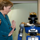 Image for article titled Why Is Angela Merkel Always Palling Around With Robots?